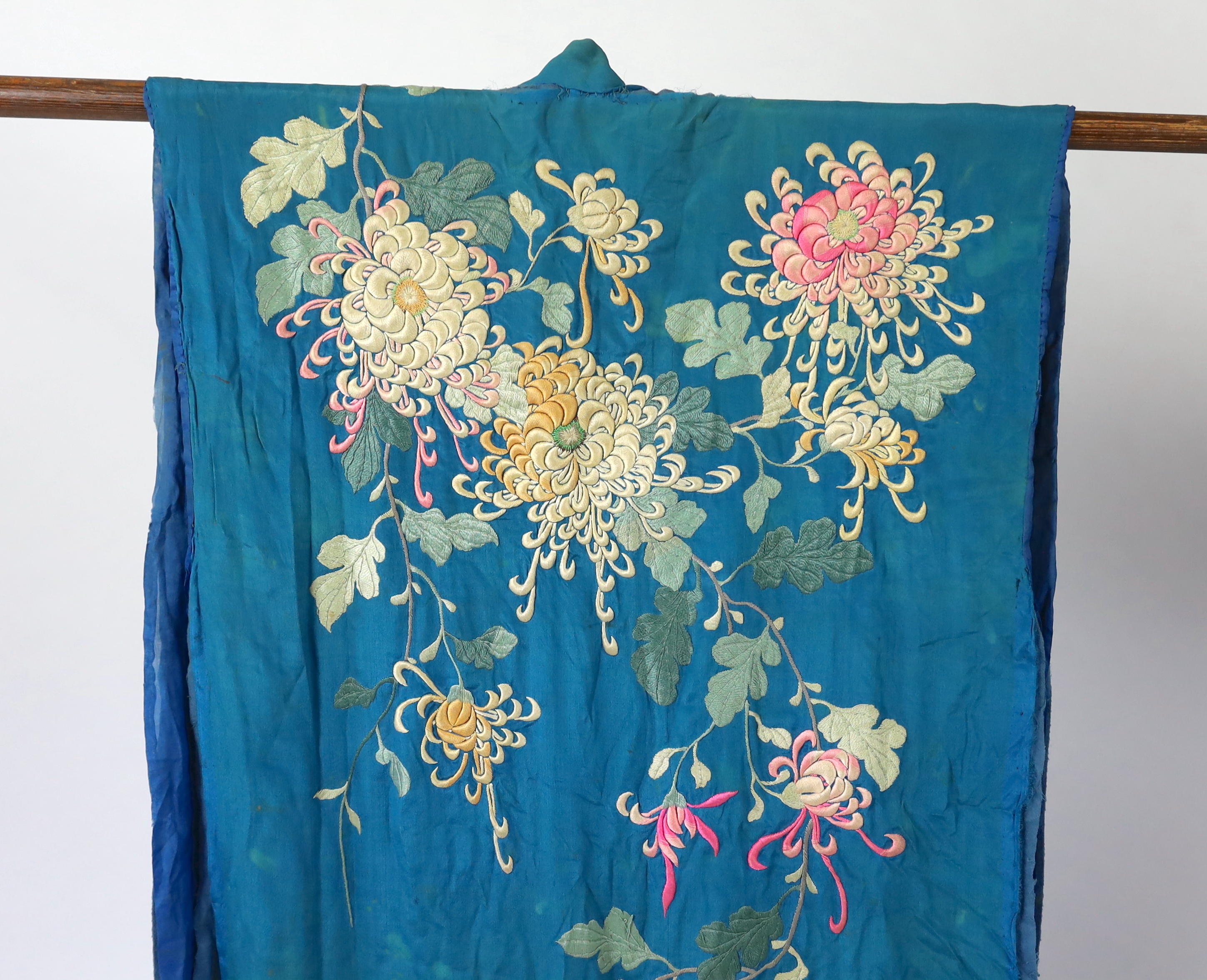 An early 20th century silk crêpe Japanese kimono and fringed tie belt, the back panel heavily embroidered with trailing chrysanthemum type flowers and leaves. This item is being sold for the back panel only and is with a